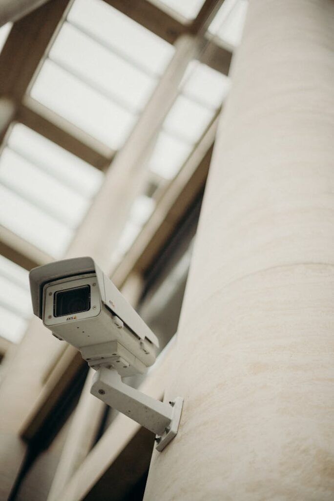 Mastering the First Impression: Your intriguing post title goes here Close-up of a security camera on a building wall, showcasing surveillance technology.